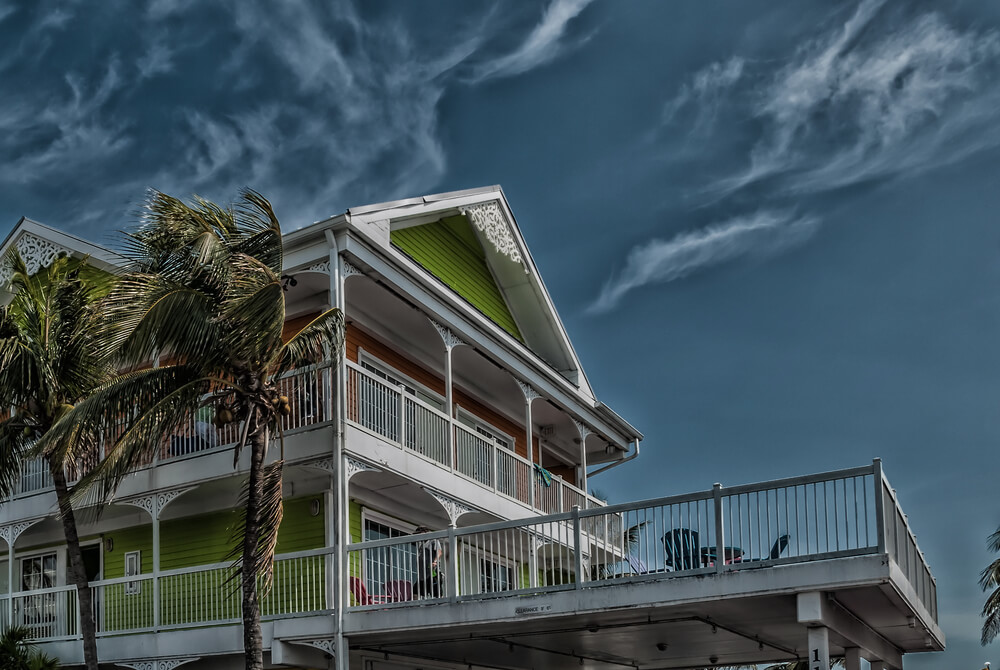 Style residential building against dark sky before tropical hurricane thunderstorm.